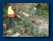 Colin (the Guide) helps Clear another Landslide that block the Road